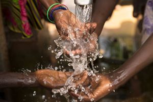 stream of water pouring on hands