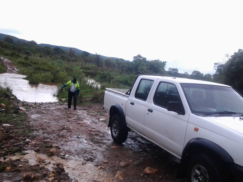 Driving over a ditch as the company car travels to a project site